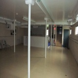 Basement of community hall with supporting poles pictured