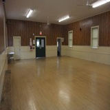 Interior of community hall, with finished wooden flooring